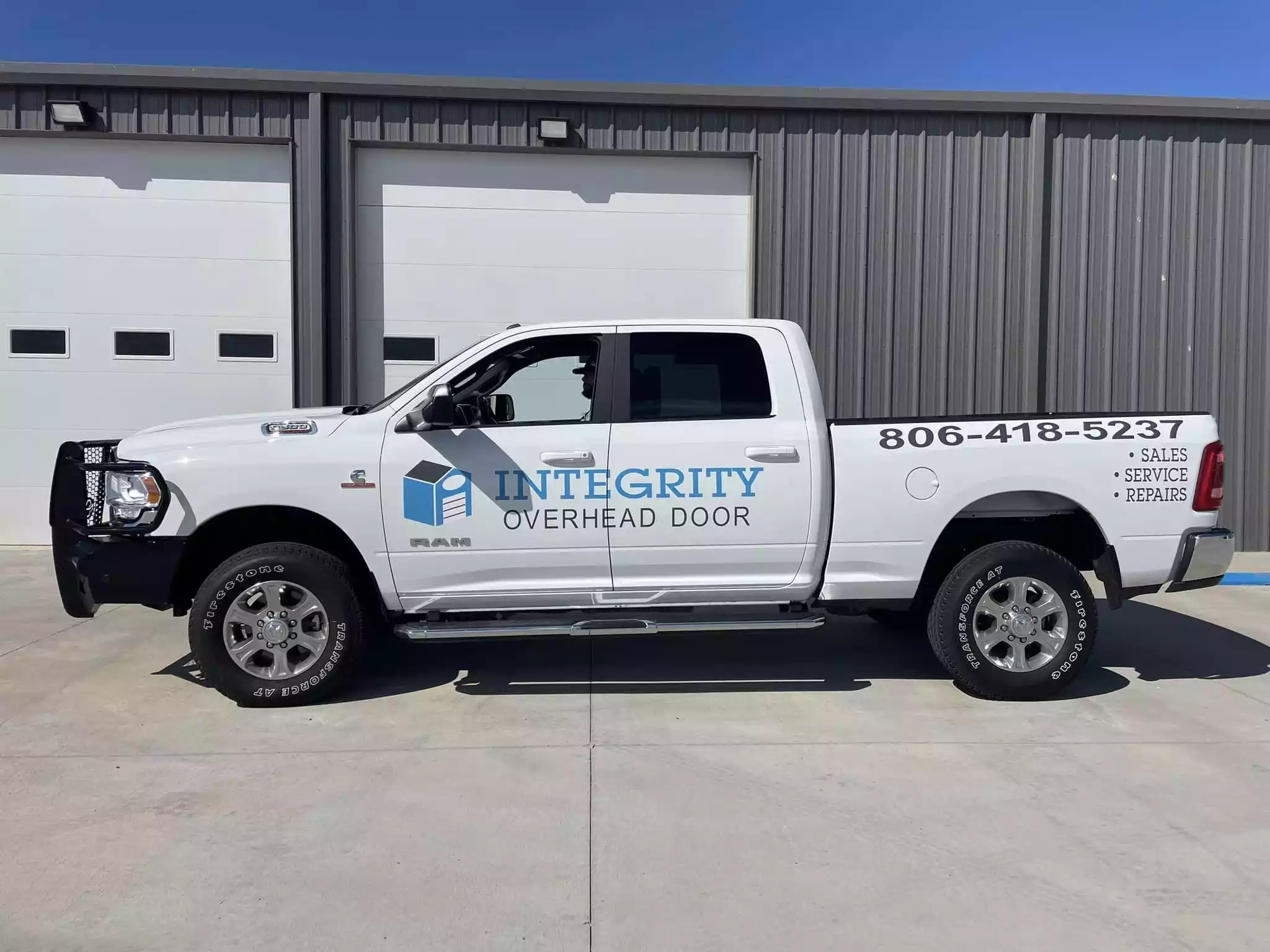 a white truck parked in front of a building - Best loading dock and door services near you in Amarillo, TX