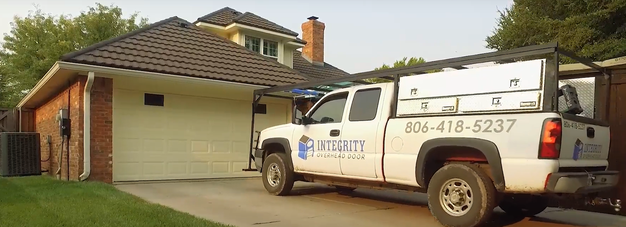 Integrity Overhead Door service truck in front of a garage door